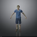 Man In Blue T Shirt And Blue Shorts Standing Against Gray Background