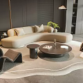 Modern Beige Curved Sofa and Round Black Coffee Table Set with Cushions on Plush Rug
