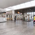 Modern Mall Shop Interior With Open Layout Display Shelves And Customer Walkway