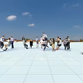 Group of People Skateboarding Standing And Talking On White Plaza Under Blue Sky