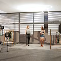 Spacious Public Office Space Featuring People Conversing Clothing Racks And Photography Gear