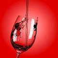 Wine Bottle And Glass On Red Background Showing Liquid Pouring Bubbles And Splashes