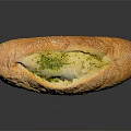 Baked Stuffed Baguette With Green Herb Filling And Sesame Seeds On Black Background