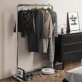 Clothes Rack with Hanging Coats Black Dresser Lamp and Sign in Modern Room Interior