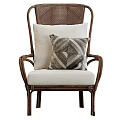 Stylish Rattan Leisure Chair With Armrests Light Colored Cushion And Geometric Pattern Pillow
