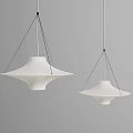 Two Modern White Disc Shaped Chandeliers Hanging With Black Cords On Grey Background