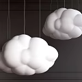 Two White Cloud Shaped Chandeliers Hanging On Dark Colored Wall
