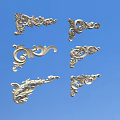 Silver Ornate Carved Decorations With Various Intricate Floral And Curved Patterns