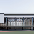 Modern School Building With White Exterior Large Glass Windows And Sports Field Area