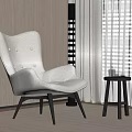 Plush White Accent Chair With Black Legs And Small Round Side Table In Modern Room