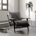 Cozy Single Sofa in Modern Room with Gray Upholstery Wooden Frame Green Plant and Books