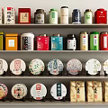 Colorful Tea Sets Display on Shelves with Various Tea Cans and Decorative Tea Cakes