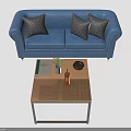 People Relaxing Together on Blue Sofa With Three Gray Pillows and Wooden Coffee Table