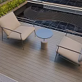 Beige Landscape Seats With Small Round Table On Wooden Deck Green Plants And Wavy Railing