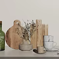 Kitchen Utensils Setup With Wooden Cutting Boards White Cups Plates Green Bottle And Small Plant