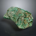 Natural Raw Green Stone With Rough Surface And Earthy Color Tones For Decor