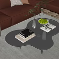 Modern Unique Shaped Black Coffee Table With Books Green Fruit Bowl Glass Vase And Plant