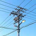 Roadside Utility Pole with Power Lines Street Lamp Blue Sky Grass and Trees