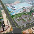 Aerial View of Modern School Campus Buildings With Green Rooftops Surrounding Roads and Sports Field