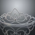 Elegant Silver Tiara with Intricate Pearl Design and Reflection on Black Background