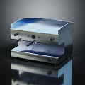 Stainless Steel Countertop Kitchen Appliance With Control Knobs And Smooth Surface