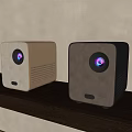 Sleek Modern Projectors Placed On Wooden Shelf With Wall Background And Plant