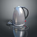 Silver Metallic Electric Kettle With Black Handle Power Cord On Reflective Surface