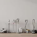 Various Vacuum Cleaners with Different Designs Displayed in a Row on Wooden Floor