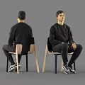 Man In Black Sweatshirt Pants And Sneakers Sitting On Chair