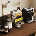 Modern Coffee Machines With Different Designs On Wooden Table And Cups