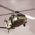 Military Helicopter Taking Off From Dusty Ground With Rotors Spinning