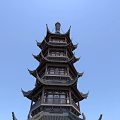 Traditional Chinese Architectural Pagoda With Multi Story Design And Overhanging Eaves Against Blue Sky