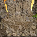 Natural Rocky Scene With Tall Stone Pillars Scattered Rubble And Small Green Plants