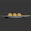 Three Yellow Balls Skewered On Bamboo Stick Served On White Plate With White Sauce