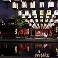 Commercial Street With Traditional Architecture Nighttime Lighting Waterfront And Pedestrians