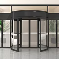 Black Frame Transparent Glass Revolving Door In Indoor Environment With Plants And Gray Floor Tiles