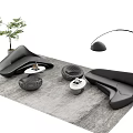 Modern Curved Black Sofa And Coffee Table Set With Gray Rug Floor Lamp And Plant