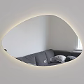 Oval Mirror with Lighted Edge Reflecting Gray Sofa and Pillows in White Wall Interior