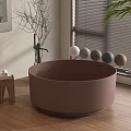 Brown Round Bathtub In Modern Interior With Wooden Floor Decorative Spheres And Green Plant