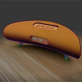 Yellow Curved Headphone Speaker on Wooden Table with Support Feet Buttons and Ports