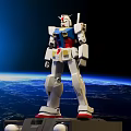 White Gundam Model With Blue Red Yellow Details Against Earth Space Background