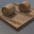 Two Round Hay Bales Placed On Square Wooden Base With Dry Straw