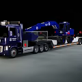 Blue Heavy Duty Utility Vehicle Transporting Excavator On Flatbed Trailer At Night