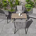 Outdoor Rattan Table And Chairs Set With Wooden Top Green Plants And Stone Tiles Floor