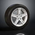 Stylish Car Tire With Silver Five Spoke Wheel Rim And Detailed Design