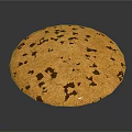 Golden Round Cookie with Dark Brown Chocolate Chips on Gray Background