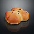 Golden Flower Shaped Raisin Bread With Shiny Crust On Black Background