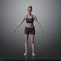 Woman Standing in Dark Sports Bra and Shorts with Arms Outstretched on Gray Background