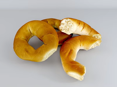 Golden Brown Freshly Baked Bagels With Bitten Pieces And Soft Interior 3d model