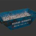 Rustic Blue Metal Container With Obras Divinity Text And Debris Inside
